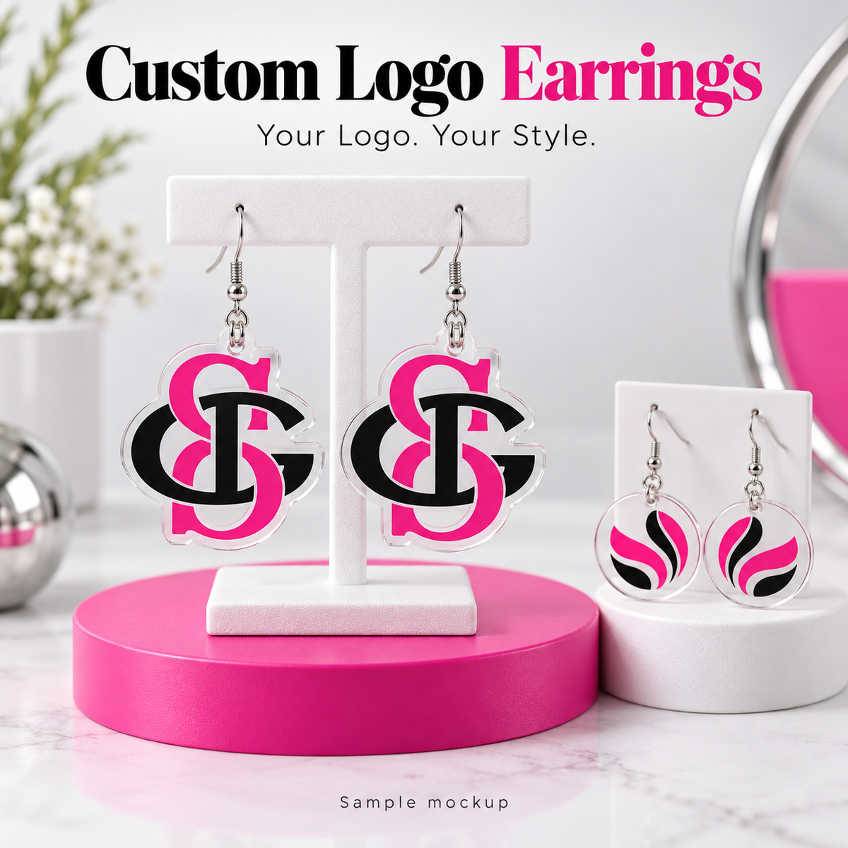 Sample mockup of custom UV-printed acrylic logo earrings in hot pink and black