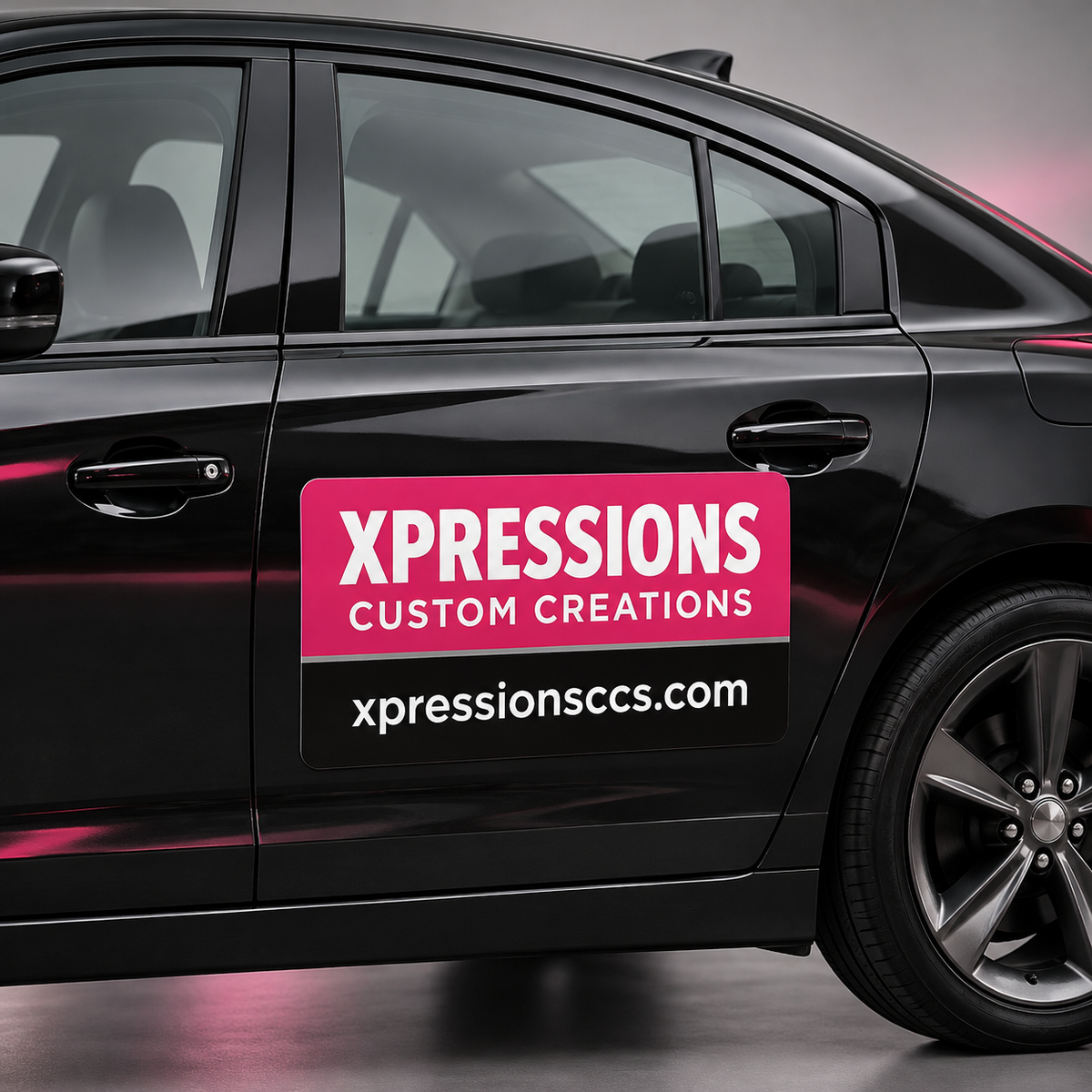 Custom car magnet mockup with pink-and-black Xpressions branding on a black sedan door.